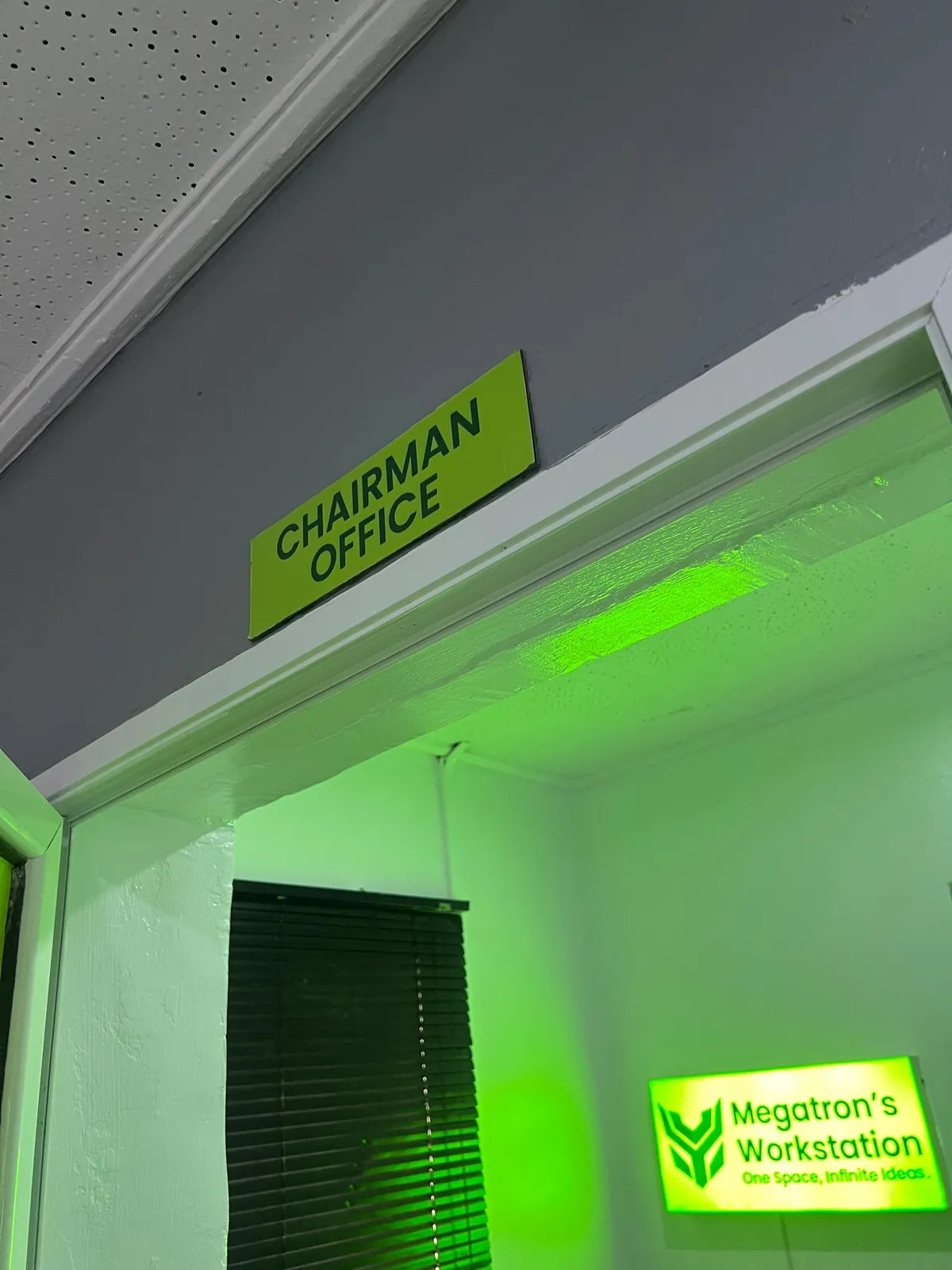 The Megatron's Workstation sign lit in green by the chairman's office